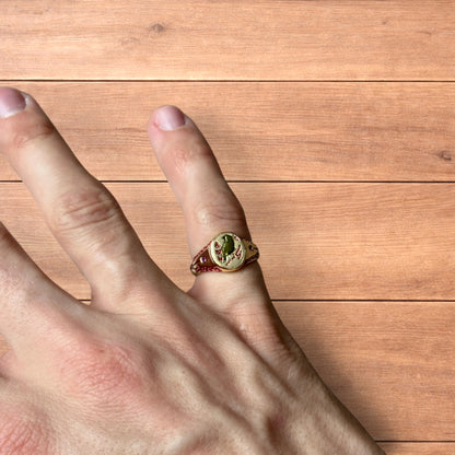 Vintage style signet ring with bird design in gold.