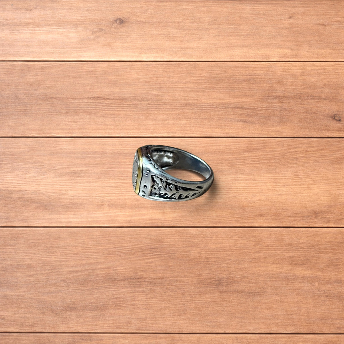 Silver chunky ring with Japanese nature design and gold trim worn on hand.