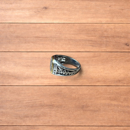 Silver chunky ring with Japanese nature design and gold trim worn on hand.