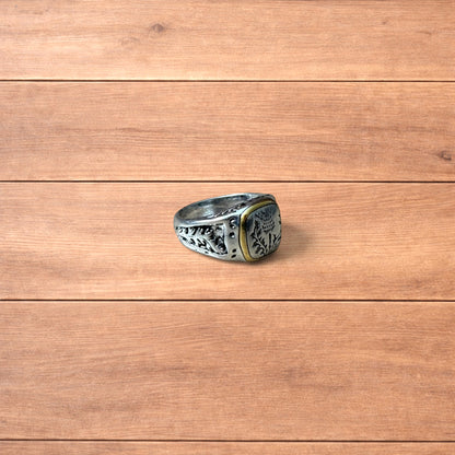 Silver chunky ring with Japanese nature design and gold trim worn on hand.