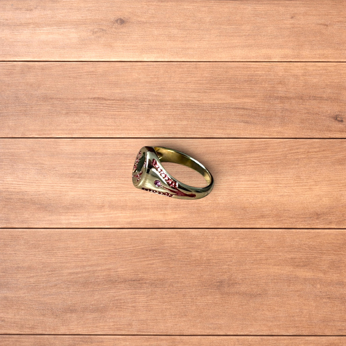 Vintage style signet ring with bird design in gold.