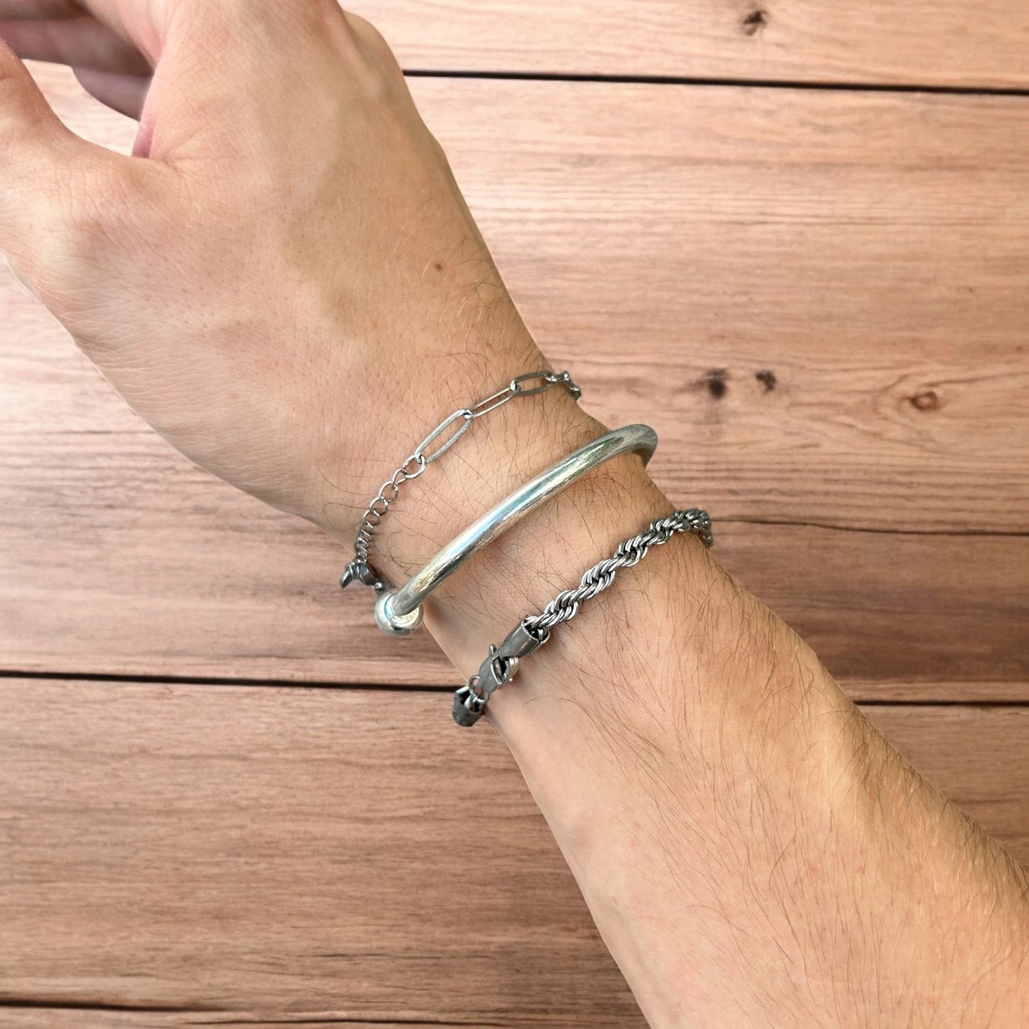 Trio of stainless steel bracelets in silver.
