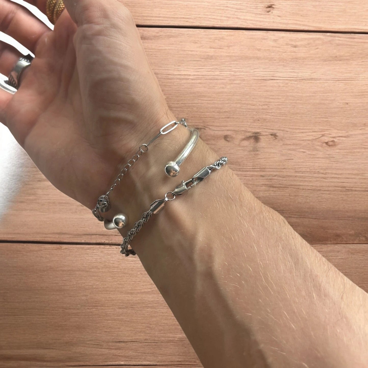 Trio of stainless steel bracelets in silver.