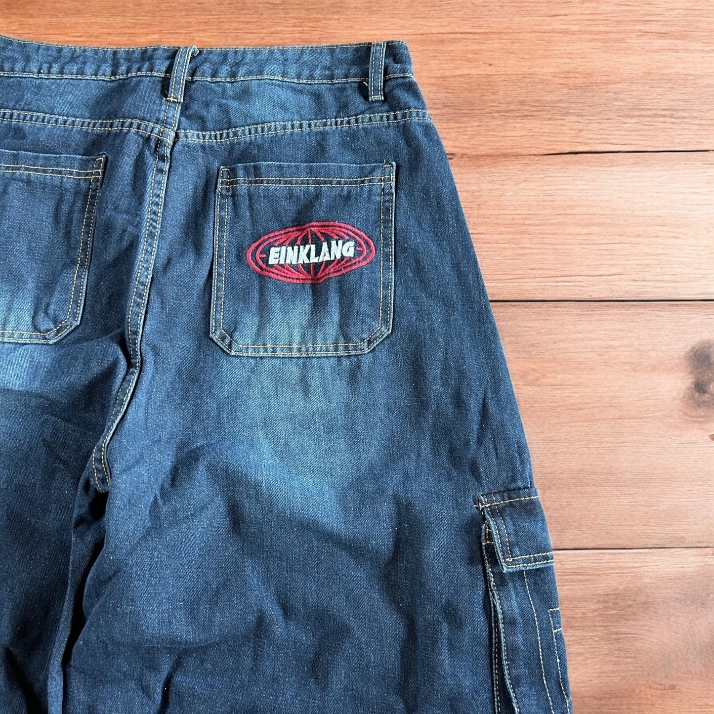 Vintage style baggy wide leg skater fit cargo jeans with embroidery in mid blue.