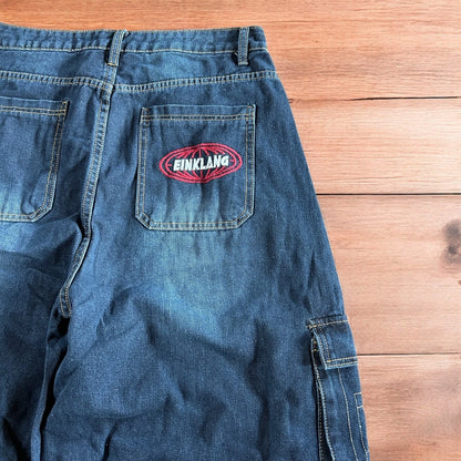 Vintage style baggy wide leg skater fit cargo jeans with embroidery in mid blue.