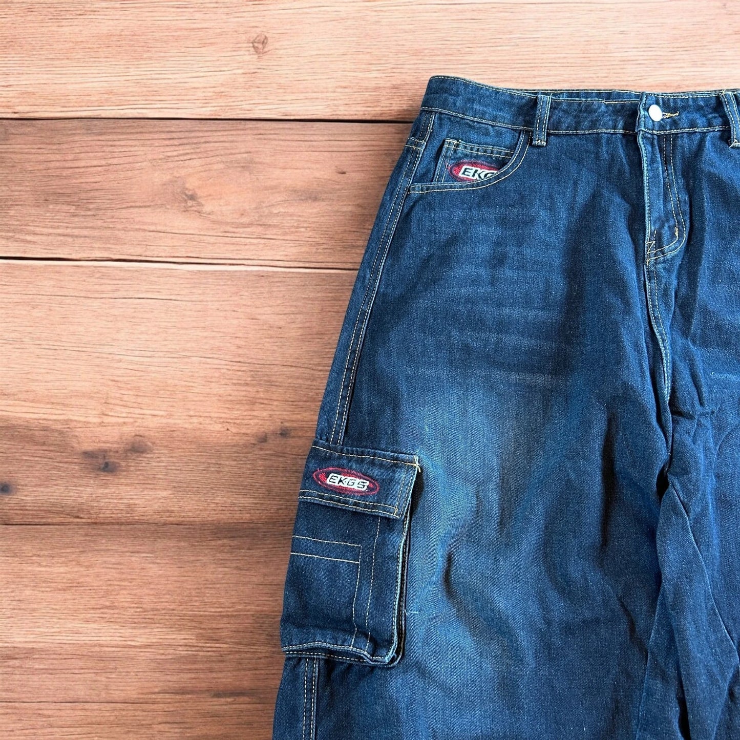 Vintage style baggy wide leg skater fit cargo jeans with embroidery in mid blue.