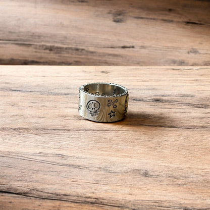 Stainless steel gothic skater skull ring in silver with gold accent. One size.