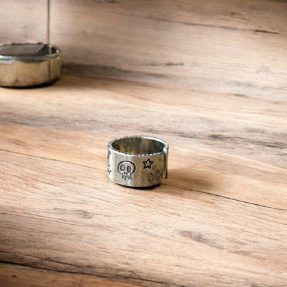 Stainless steel gothic skater skull ring in silver with gold accent. One size.