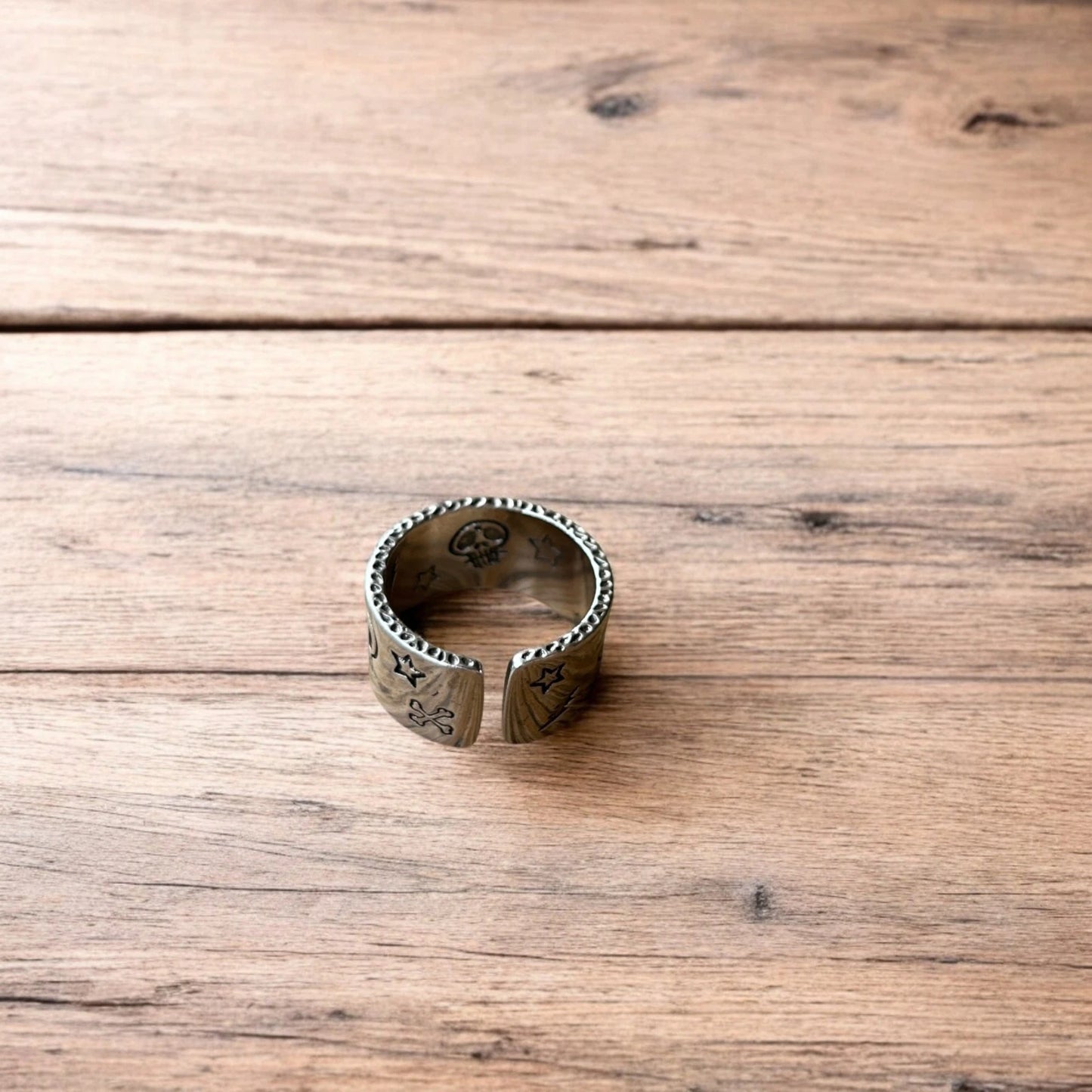 Stainless steel gothic skater skull ring in silver with gold accent. One size.